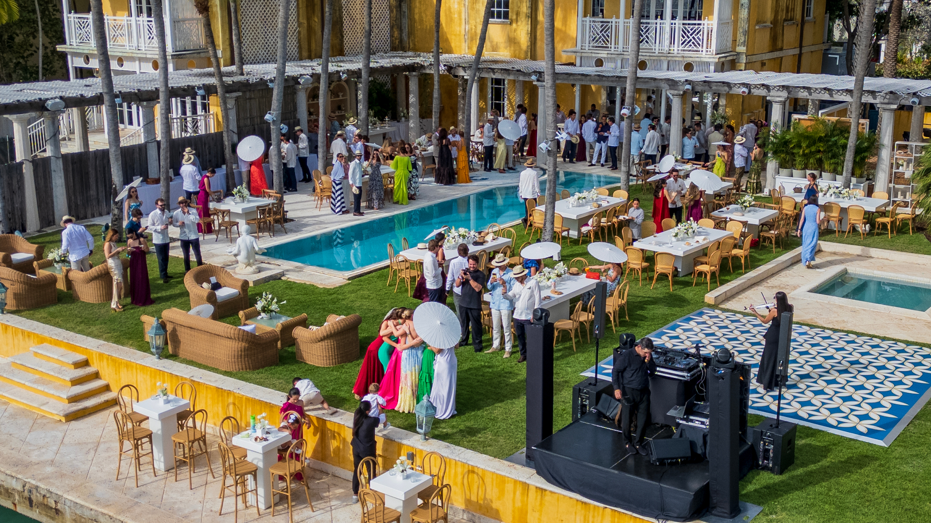Aerial view of luxury outdoor event with poolside dining