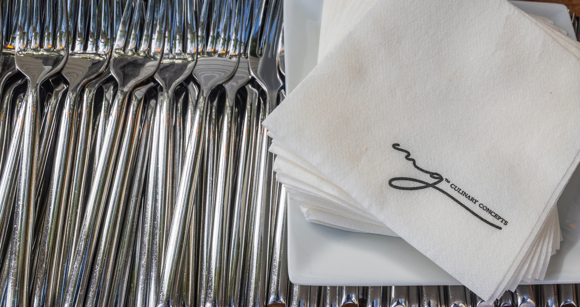 Polished forks and branded MG Culinary Concepts napkins